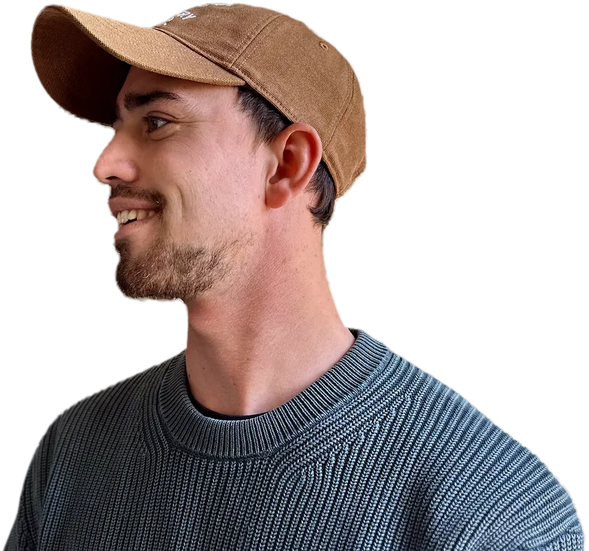 Reynard du Toit, wearing a cap, looking off to one side